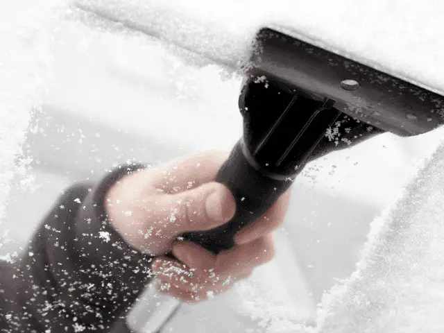 Ice Scraper Removing Ice from Windshield