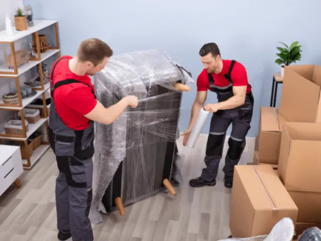 Professional Movers Wrapping a Couch