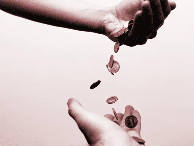 Money Being Dropped Into Hands